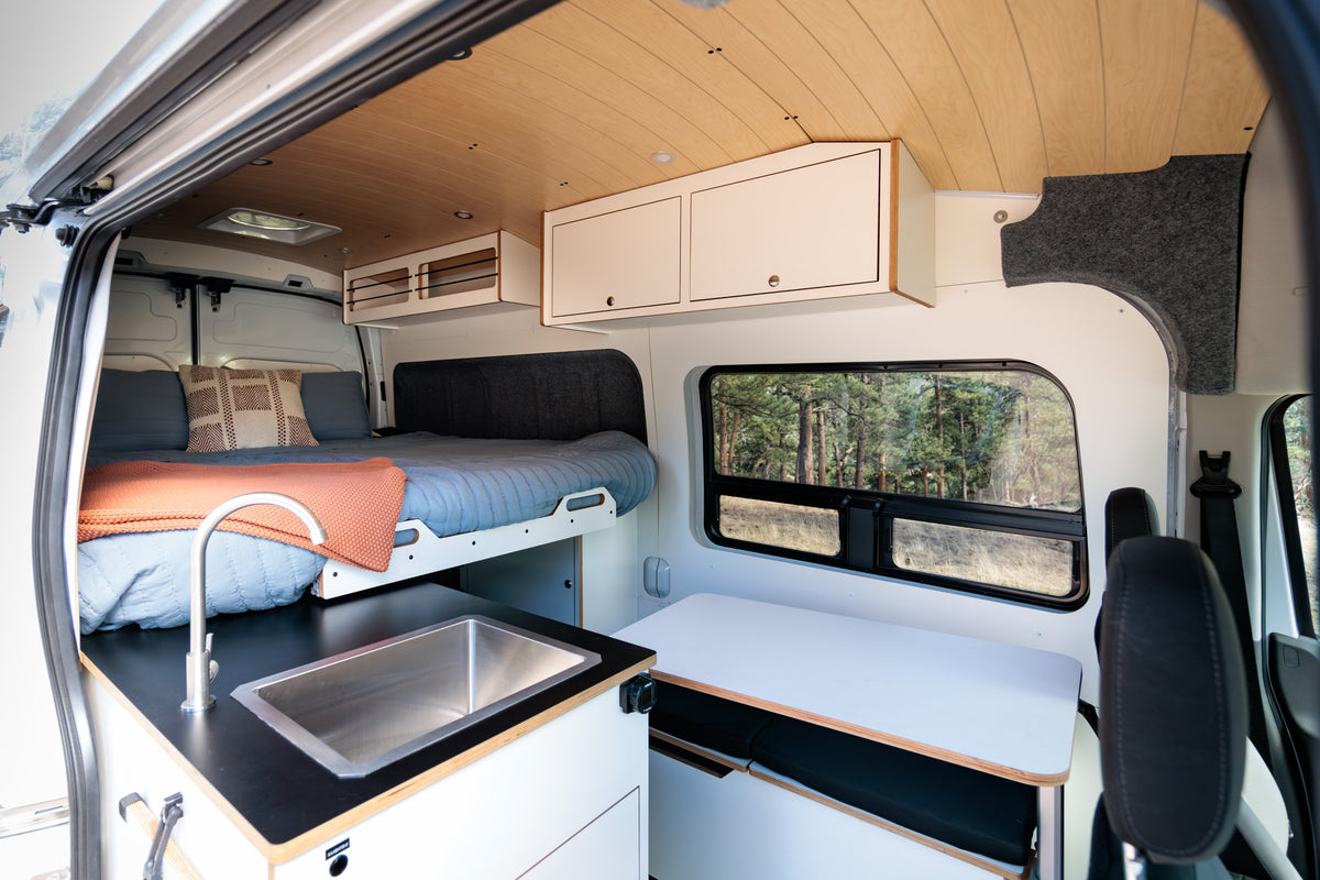 Interior with galley sink, Lagun table and rear bench seating by the window