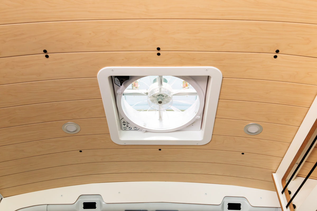 Ceiling fan and recessed lighting in the slat-style birch ceiling